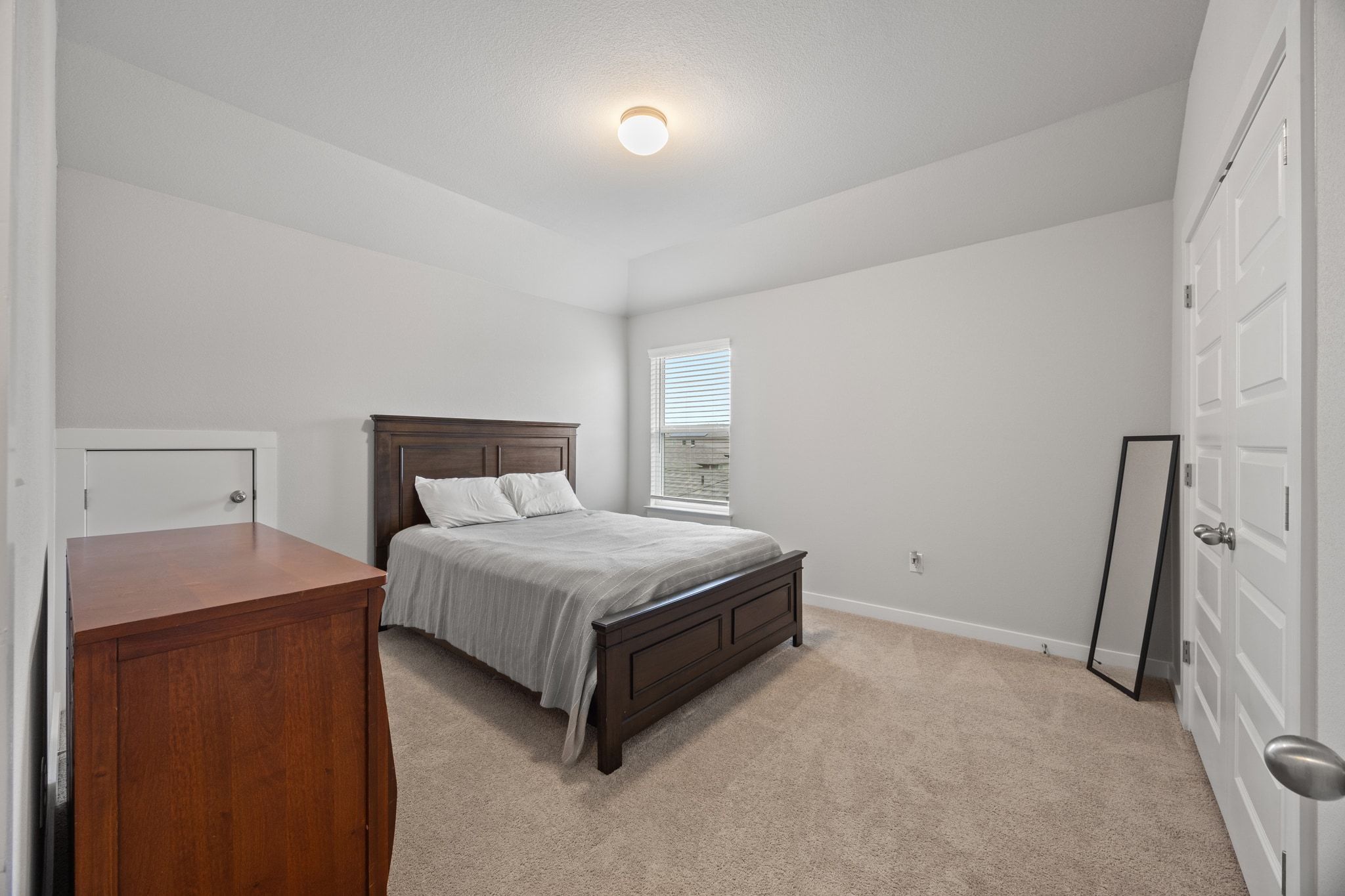 161 Appleberry Lane Elgin, TX 78621 - Photo 31 of 40 a bedroom with a bed and a mirror