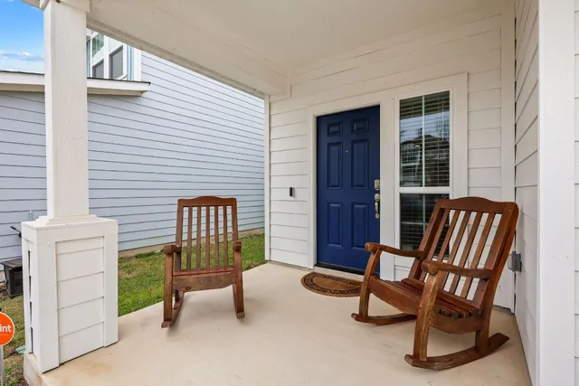 a balcony with chairs and a table