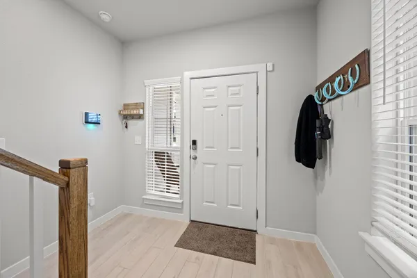 a view of hallway with walk in closet and window