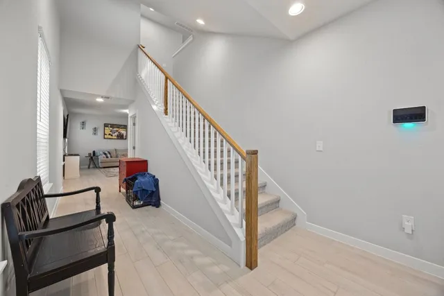 a view of staircase and living room with windows