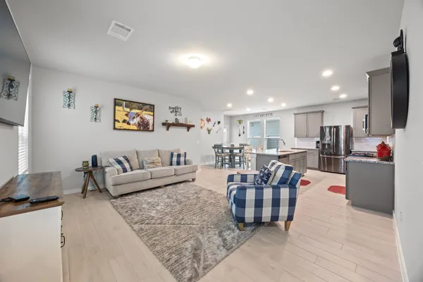 a living room with furniture kitchen view and a couch