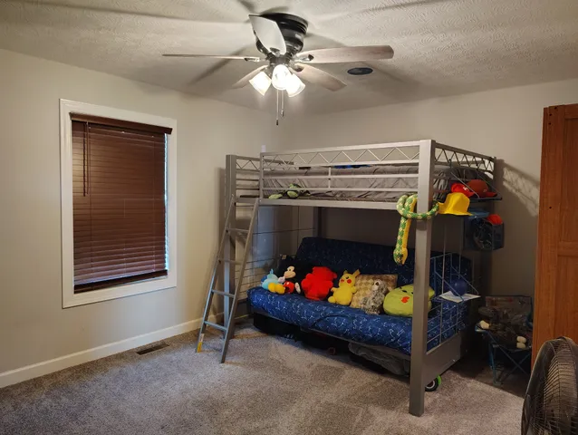 a bed room with furniture and a window