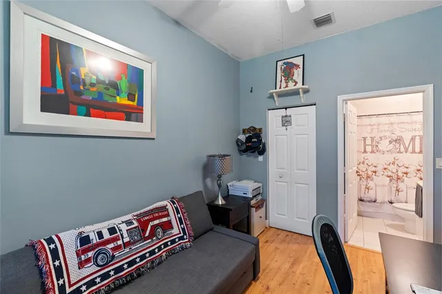 a bedroom with furniture and a painting on the wall