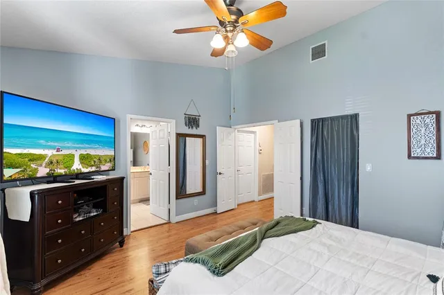 a bedroom with a bed and a flat screen tv