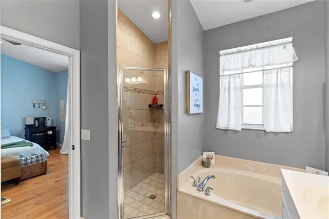 a bathroom with a tub and shower