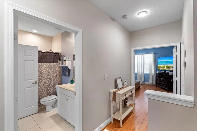a bathroom with a toilet a sink and a mirror