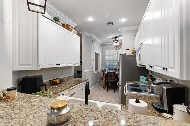 a kitchen with a sink and a stove top oven