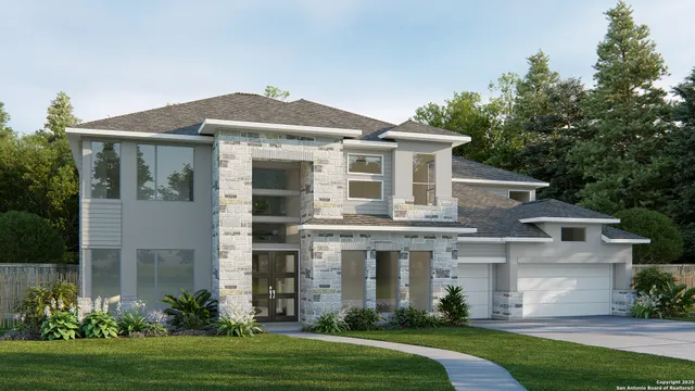 a front view of a house with a yard and trees