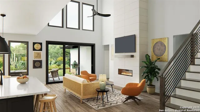 a living room with furniture a flat screen tv and large windows