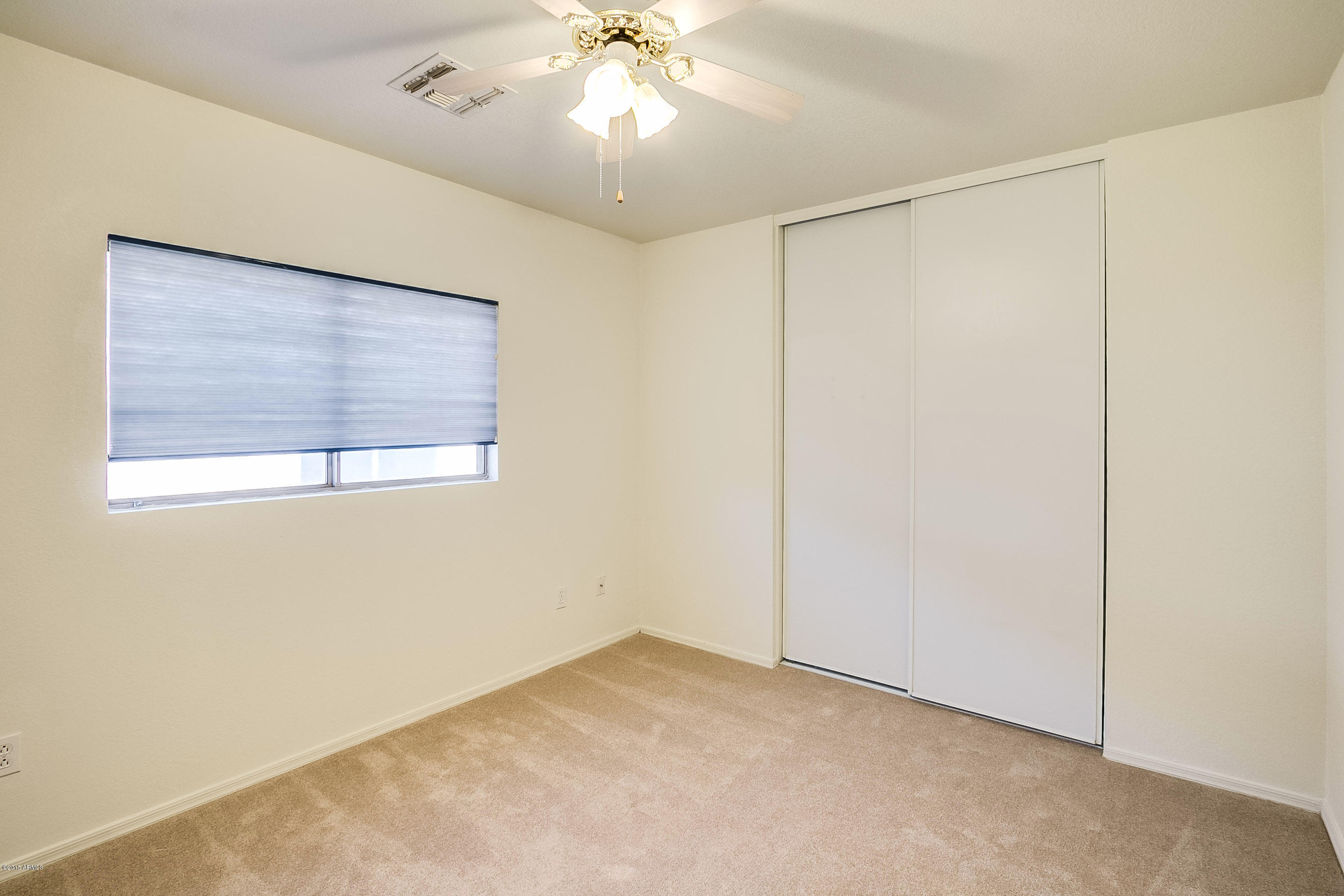 445 West Aviary Way Gilbert, AZ 85233 - Photo 16 of 27 an empty room with a window and a fan