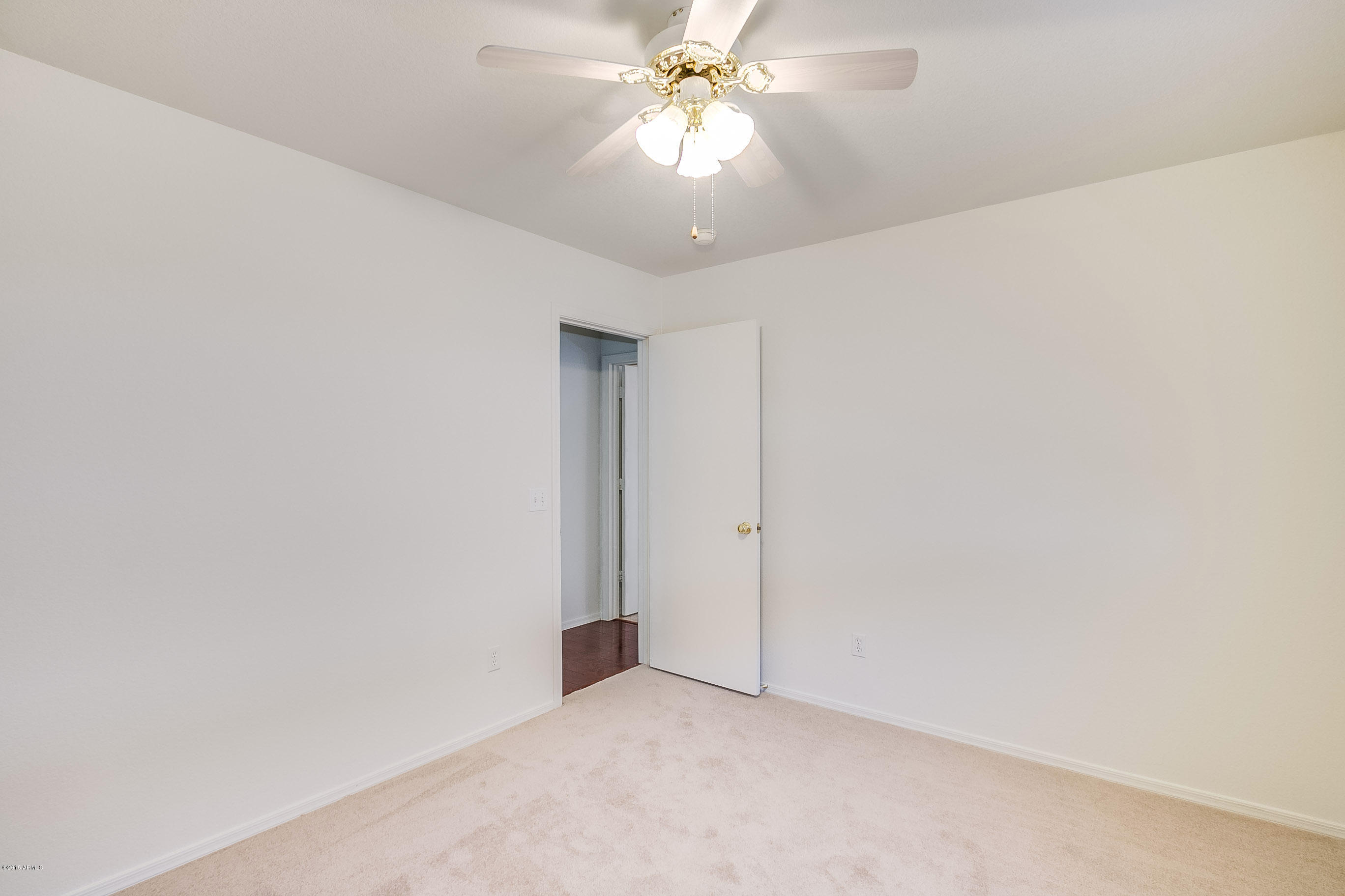 445 West Aviary Way Gilbert, AZ 85233 - Photo 17 of 27 an empty room with a chandelier fan and closet area