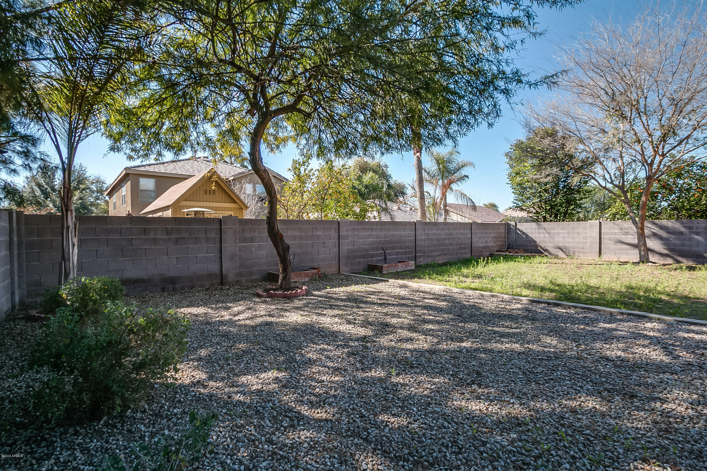 445 West Aviary Way Gilbert, AZ 85233 - Photo 24 of 27 a view of a backyard with wooden fence