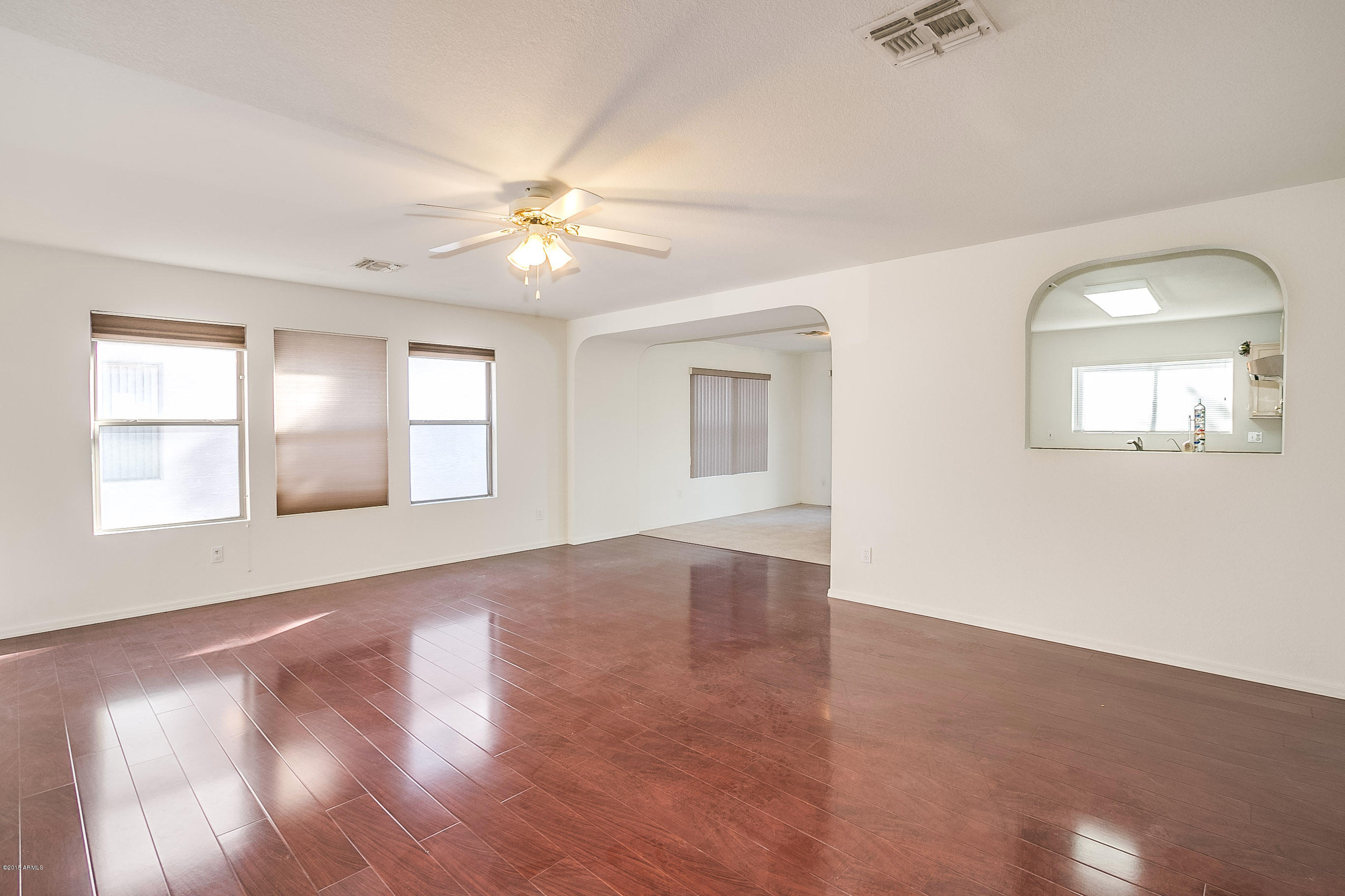 445 West Aviary Way Gilbert, AZ 85233 - Photo 3 of 27 wooden floor in an empty room with a window