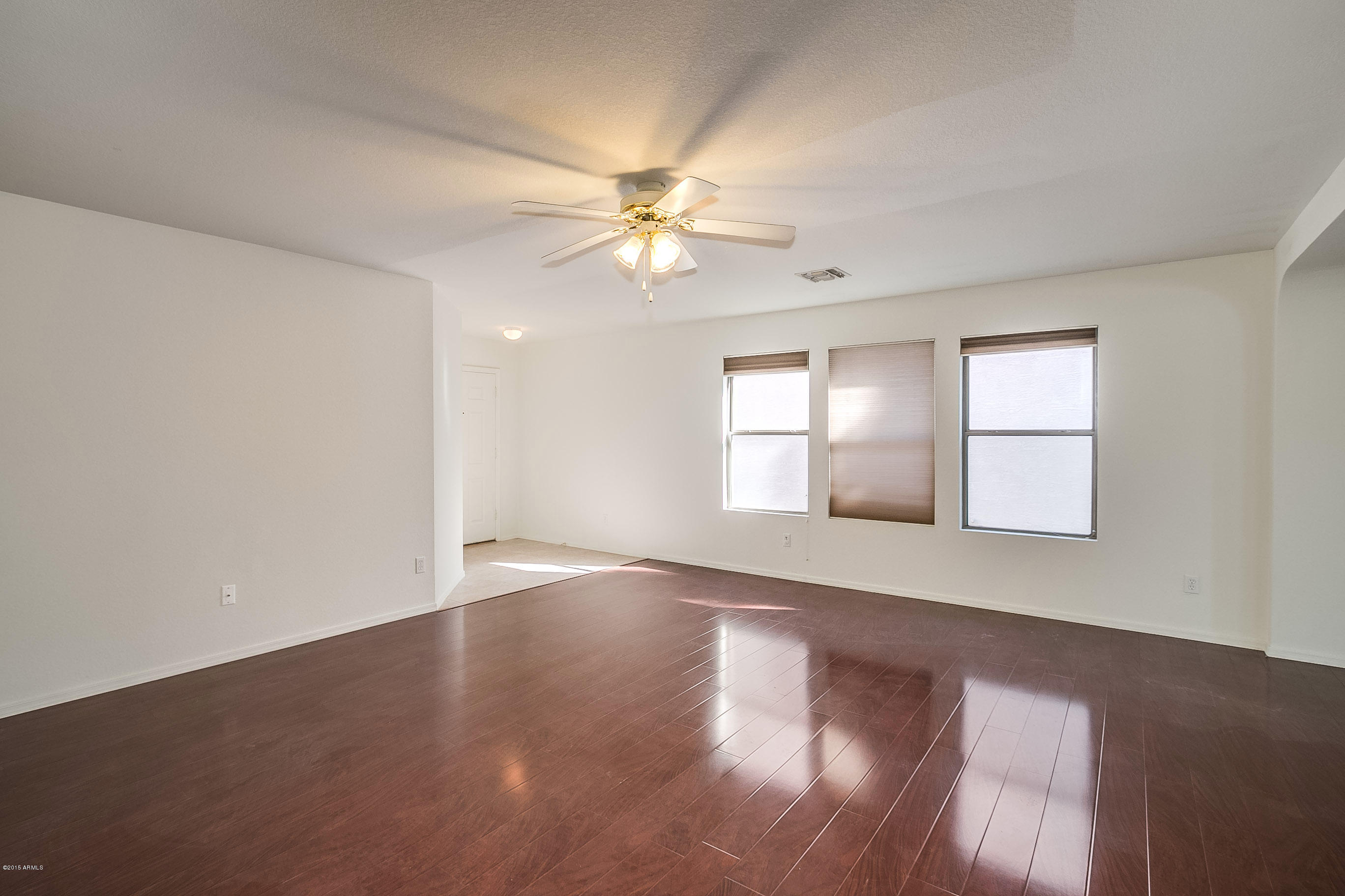 445 West Aviary Way Gilbert, AZ 85233 - Photo 4 of 27 an empty room with wooden floor and windows