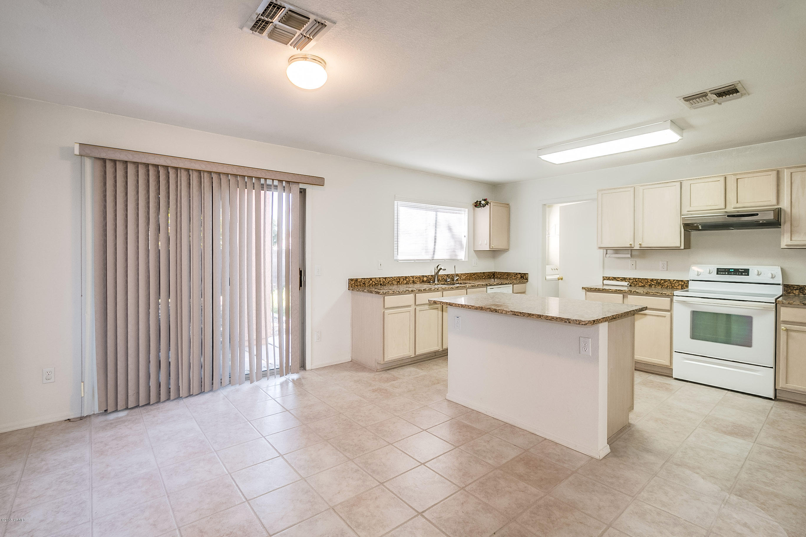 445 West Aviary Way Gilbert, AZ 85233 - Photo 5 of 27 a kitchen with white cabinets and appliances