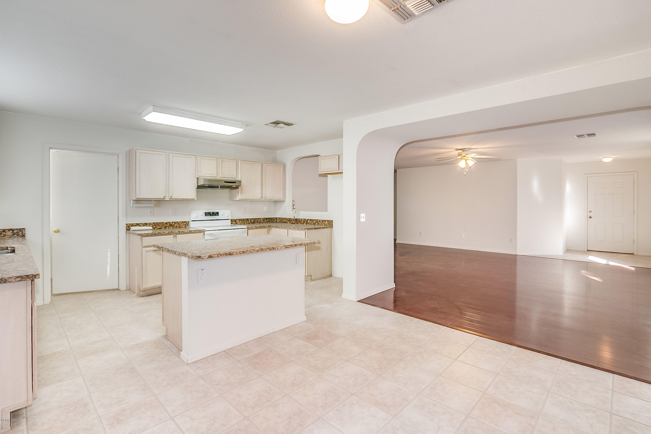 445 West Aviary Way Gilbert, AZ 85233 - Photo 6 of 27 a kitchen with a refrigerator and a stove top oven