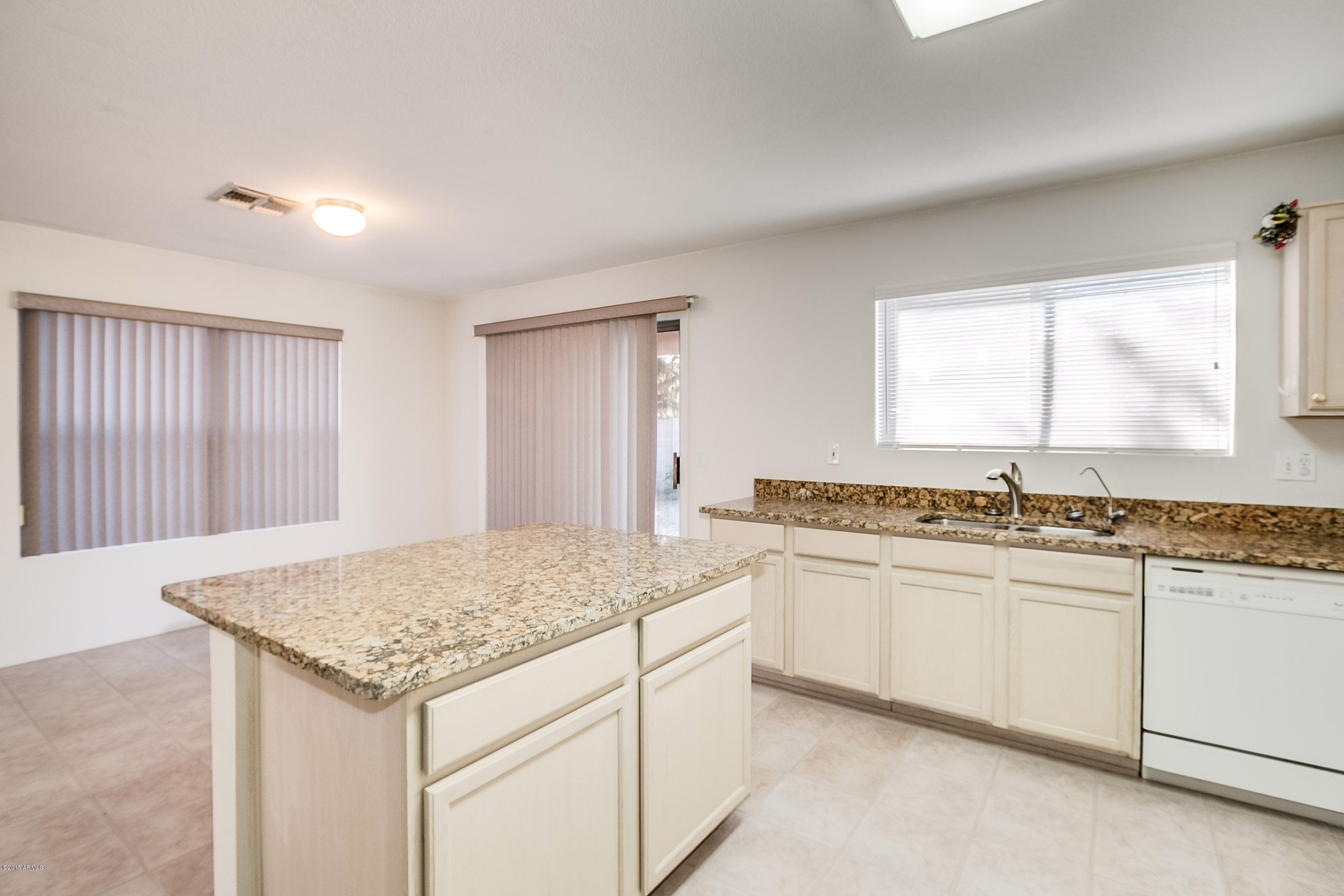 445 West Aviary Way Gilbert, AZ 85233 - Photo 8 of 27 a kitchen with a sink stove and cabinets