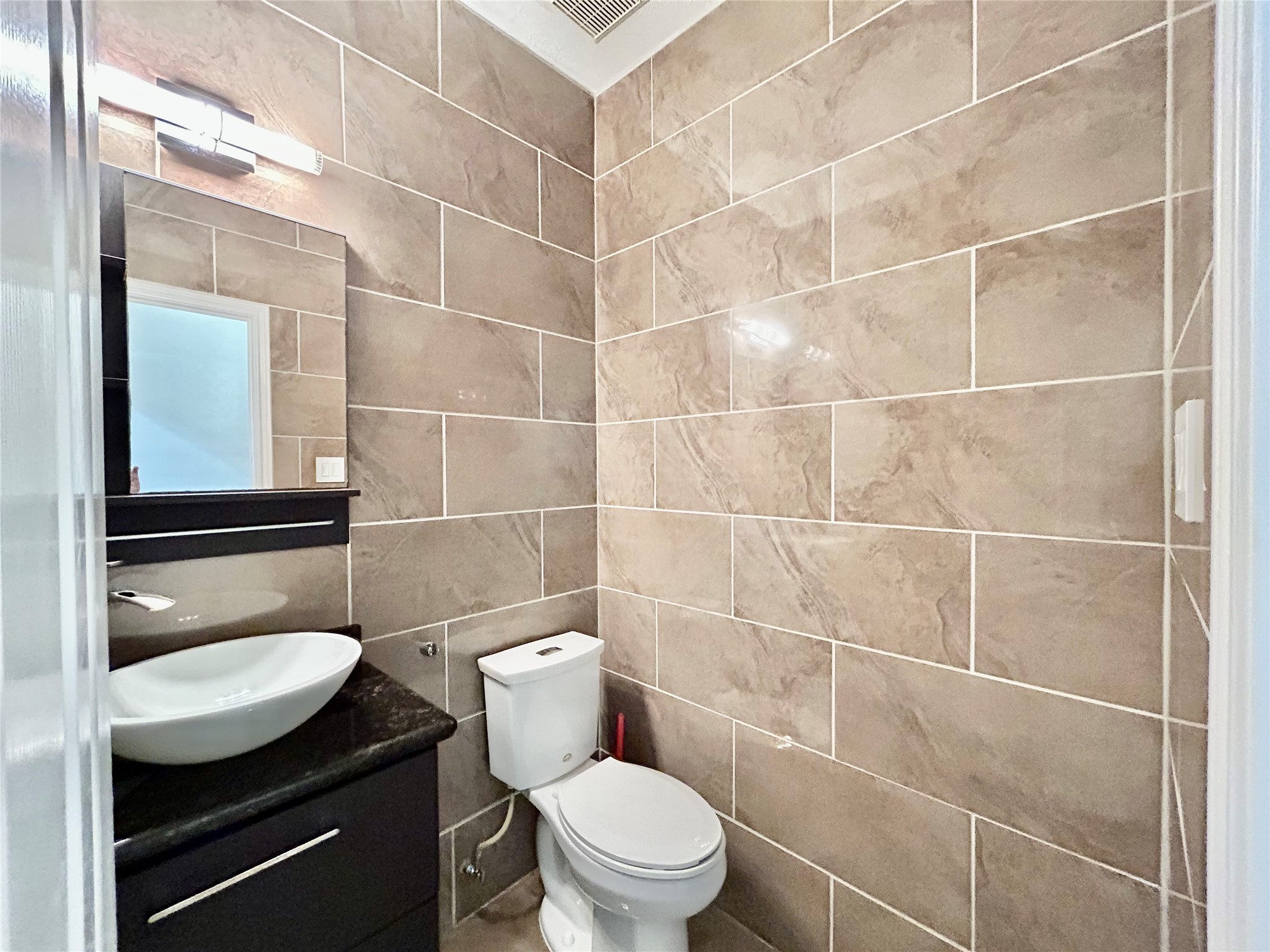 22918 Breton Point Drive Spring, TX 77373 - Photo 12 of 49 a bathroom with a toilet a sink and mirror