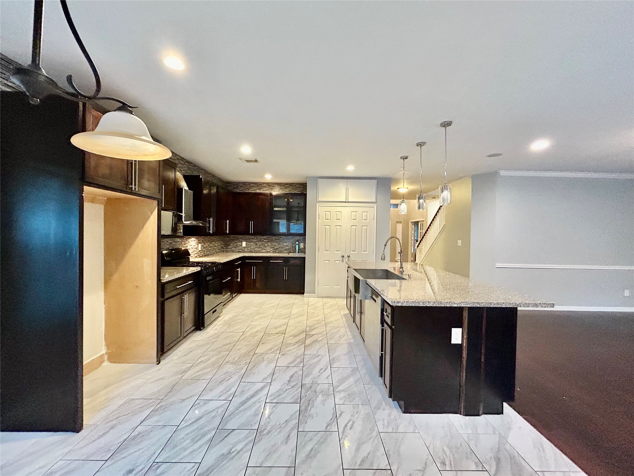 22918 Breton Point Drive Spring, TX 77373 - Photo 14 of 49 a kitchen with stainless steel appliances kitchen island granite countertop a sink and a refrigerator