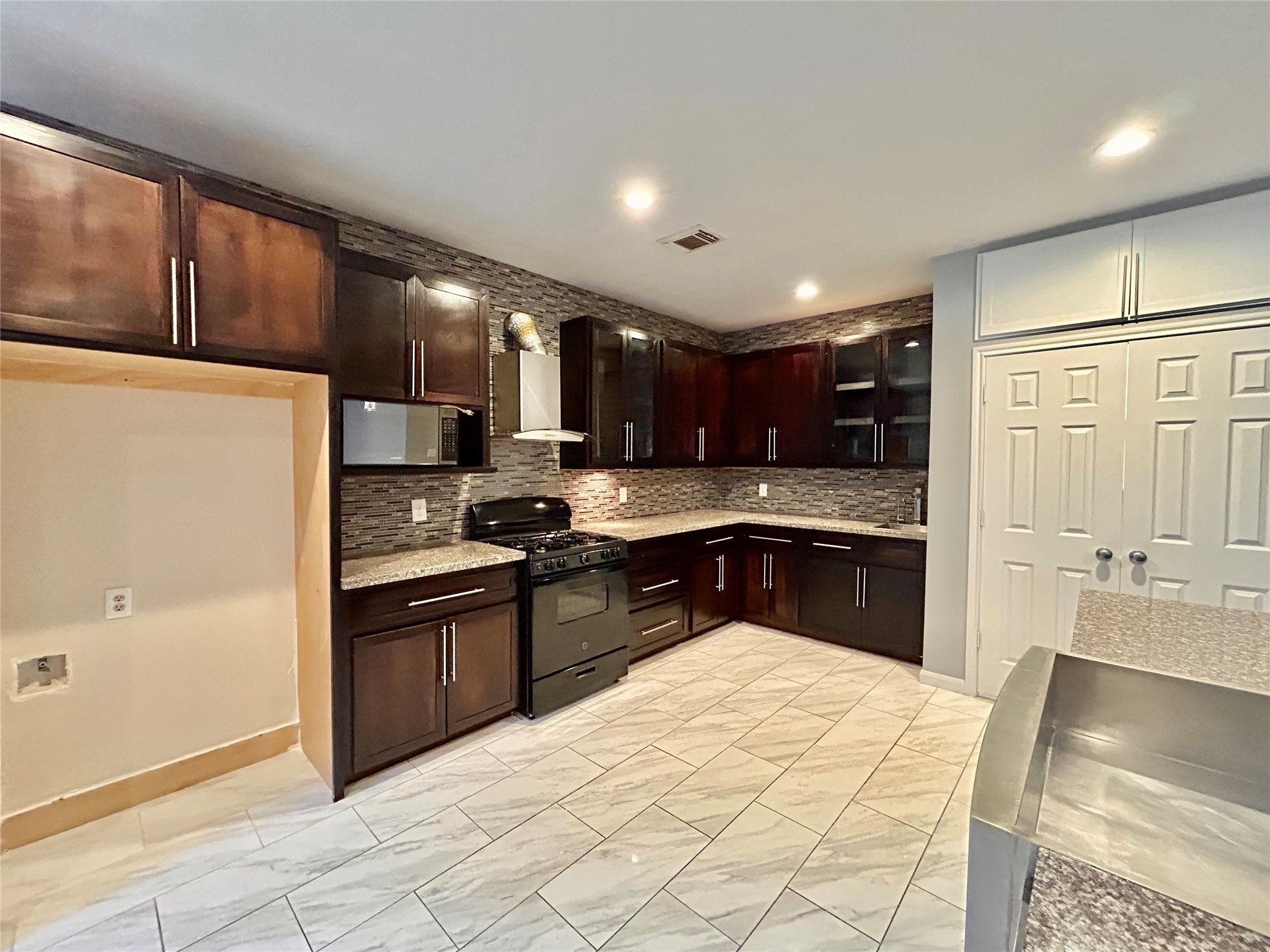 22918 Breton Point Drive Spring, TX 77373 - Photo 15 of 49 a kitchen with stainless steel appliances granite countertop a refrigerator a sink and a stove