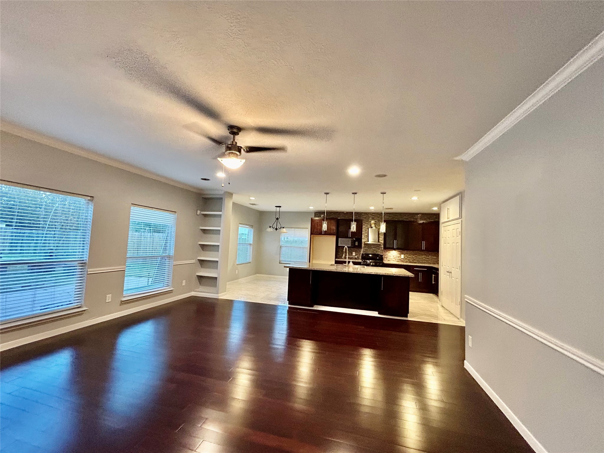 22918 Breton Point Drive Spring, TX 77373 - Photo 21 of 49 a living room with stainless steel appliances kitchen island wooden floors and view living room