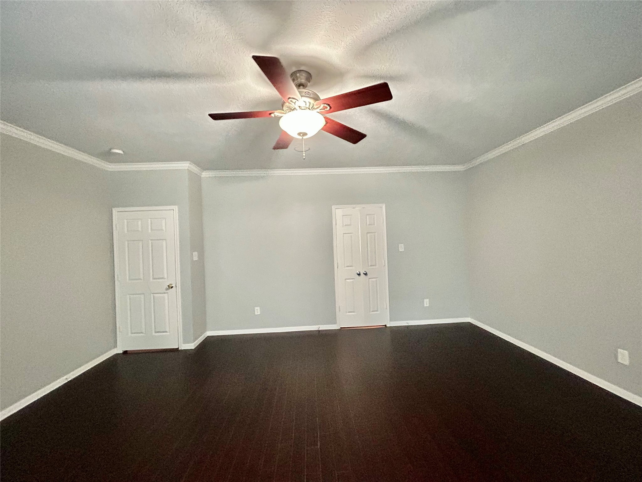 22918 Breton Point Drive Spring, TX 77373 - Photo 25 of 49 en empty room with wooden floor and windows