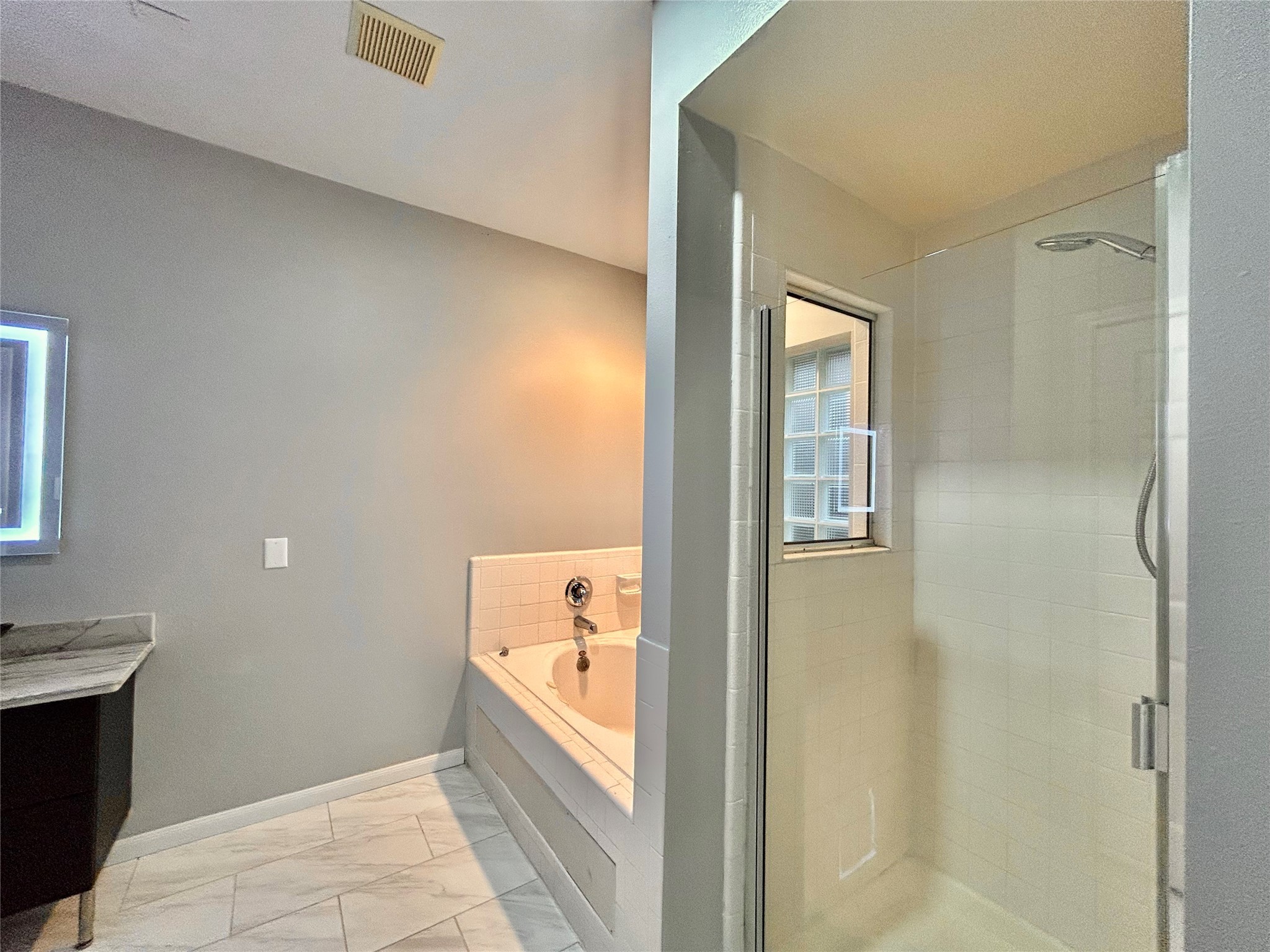 22918 Breton Point Drive Spring, TX 77373 - Photo 26 of 49 a bathroom with a tub shower and sink