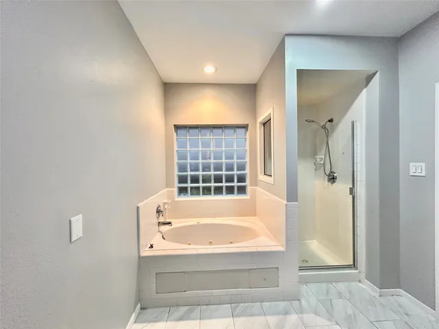 a bathroom with a bathtub and shower