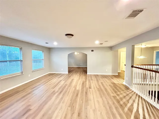 a view of an empty room and wooden floor