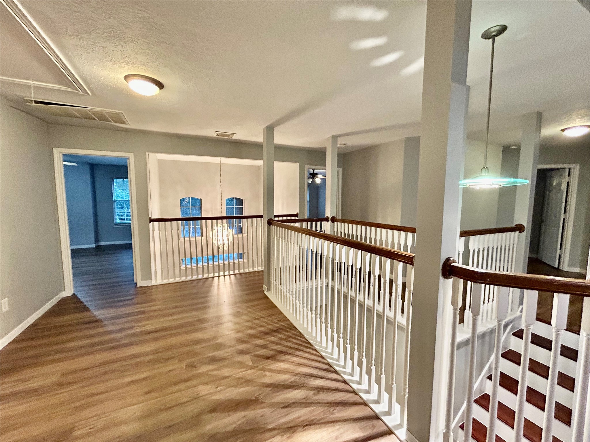 22918 Breton Point Drive Spring, TX 77373 - Photo 34 of 49 a view of a hallway with wooden floor and windows
