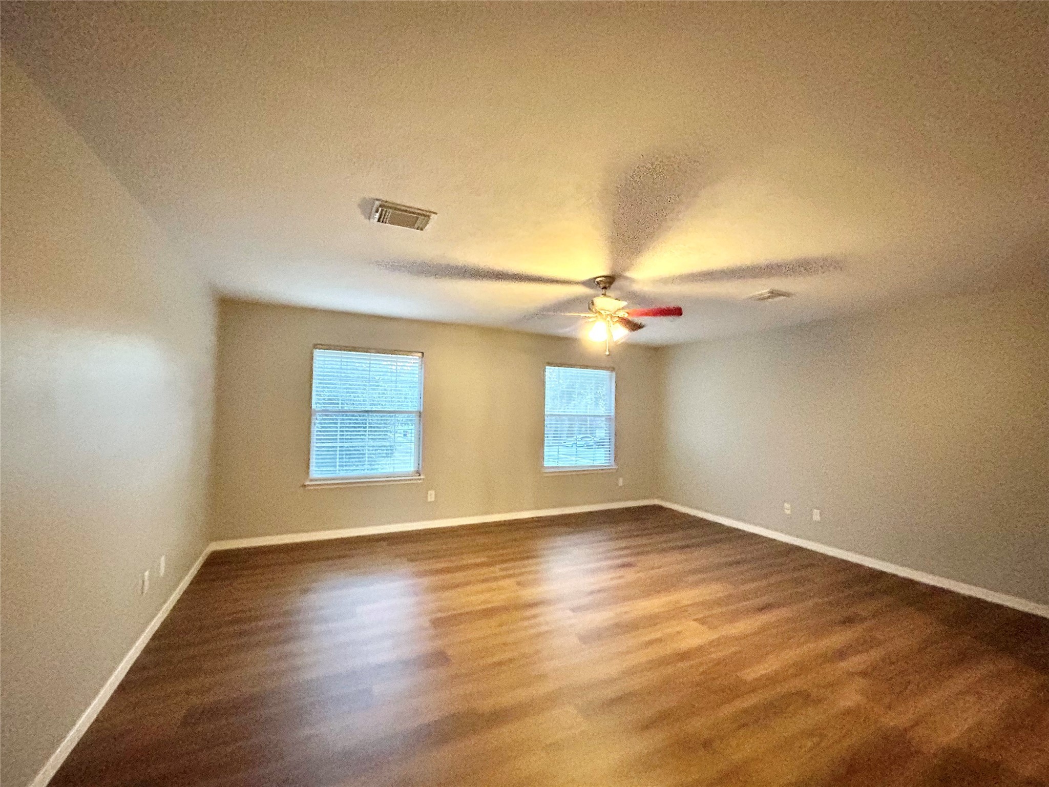 22918 Breton Point Drive Spring, TX 77373 - Photo 41 of 49 an empty room with wooden floor fan and window