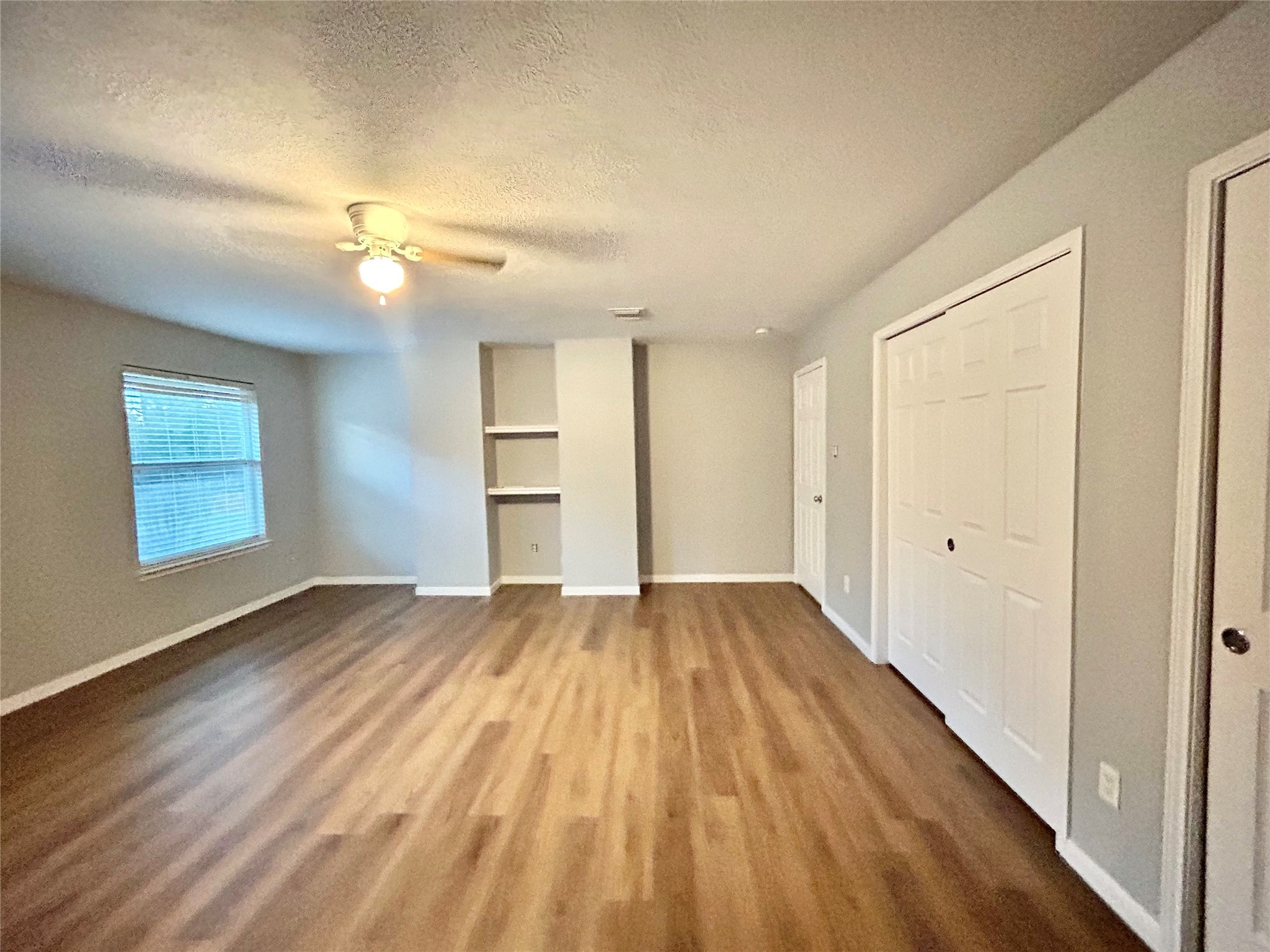 22918 Breton Point Drive Spring, TX 77373 - Photo 45 of 49 a view of empty room with wooden floor and fan