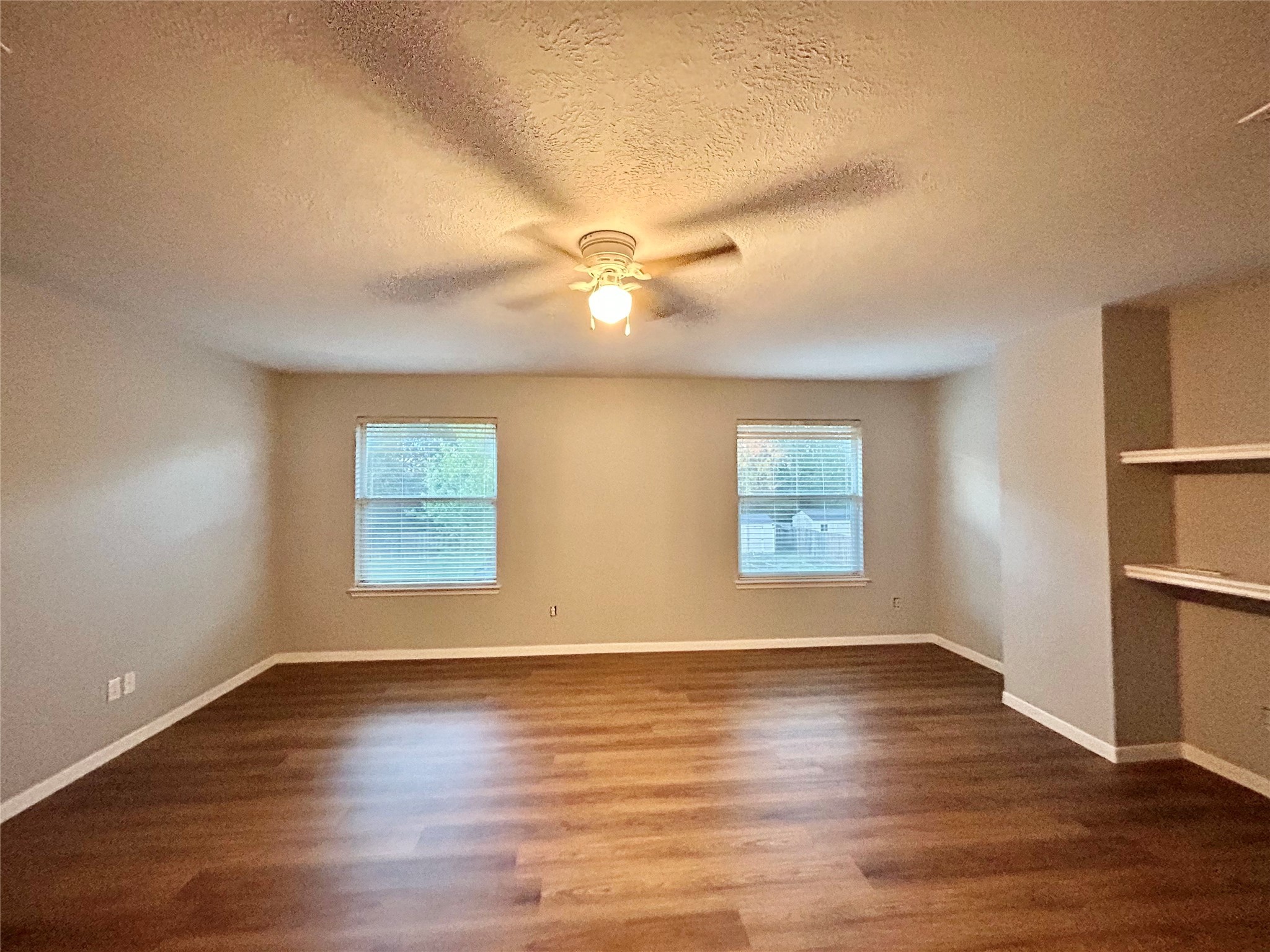 22918 Breton Point Drive Spring, TX 77373 - Photo 46 of 49 an empty room with wooden floor and windows