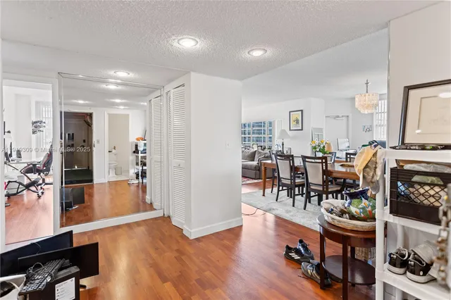 a view of a workspace with furniture and wooden floor
