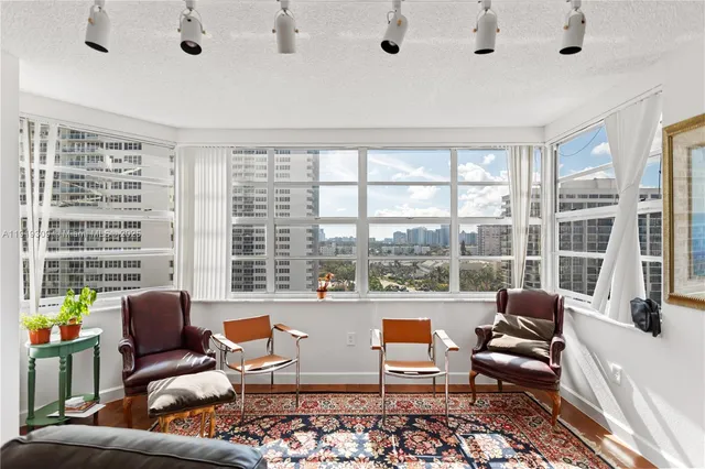 a living room with furniture dining area and a window