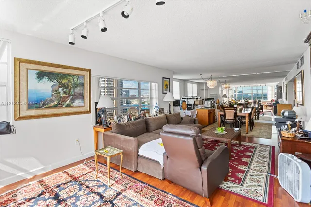 a view of a hallway with wooden floor and furniture
