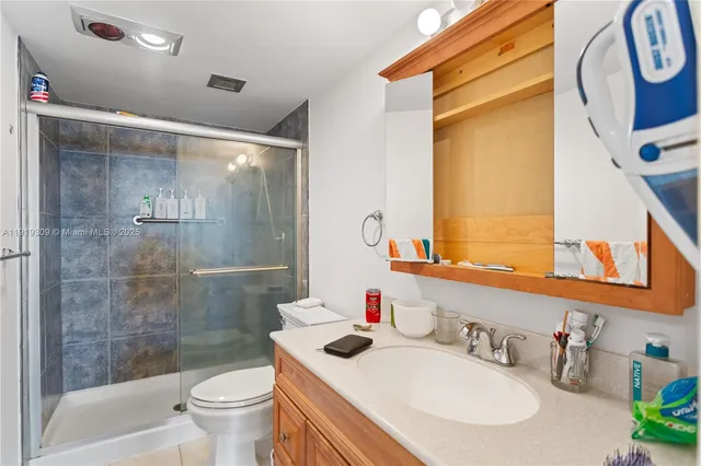 a bedroom with a bed and a flat tv screen on the dresser