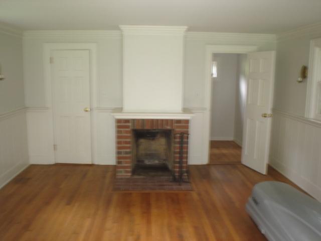 3 Intervale Place Greenwich, CT 06830 - Photo 12 of 13 an empty room with wooden floor and fireplace