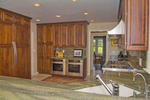 3 Intervale Place Greenwich, CT 06830 - Photo 8 of 13 a kitchen with stainless steel appliances granite countertop a refrigerator a stove and a sink with wooden cabinets