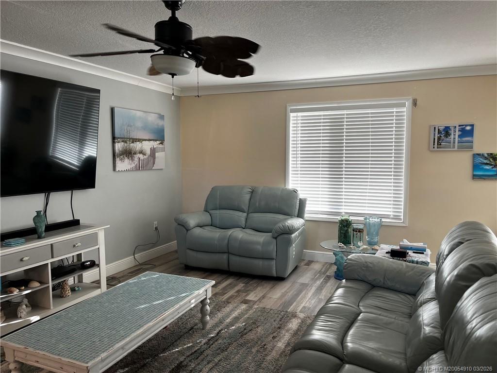 5323 Southeast Miles Grant Road, Unit 206 Stuart, FL 34997 - Photo 8 of 20 a living room with furniture and a window