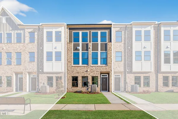 front view of a brick building next to a yard