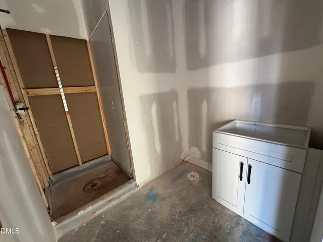 a view of storage and utility room with refrigerator