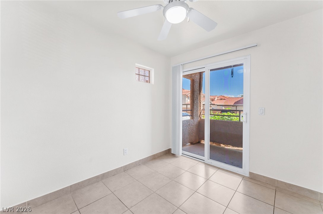 9325 West Desert Inn Road, Unit 177 Las Vegas, NV 89117 - Photo 6 of 24 Sliding glass doors open from tiled flooring to a private outdoor balcony.