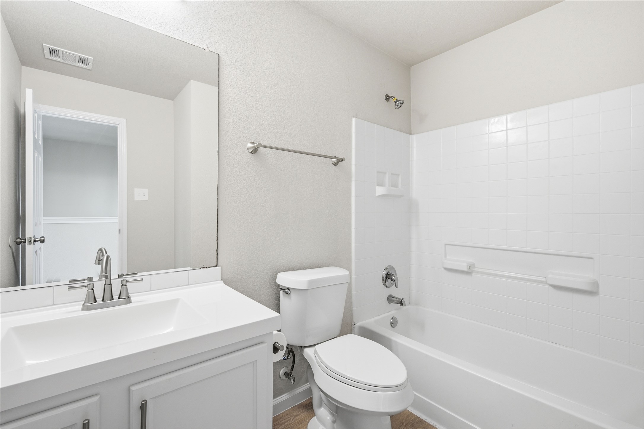 6917 Panda Royle Drive Del Valle, TX 78617 - Photo 19 of 23 A well-appointed bathroom features a single vanity, a standard toilet, and a tiled shower-bathtub combination.