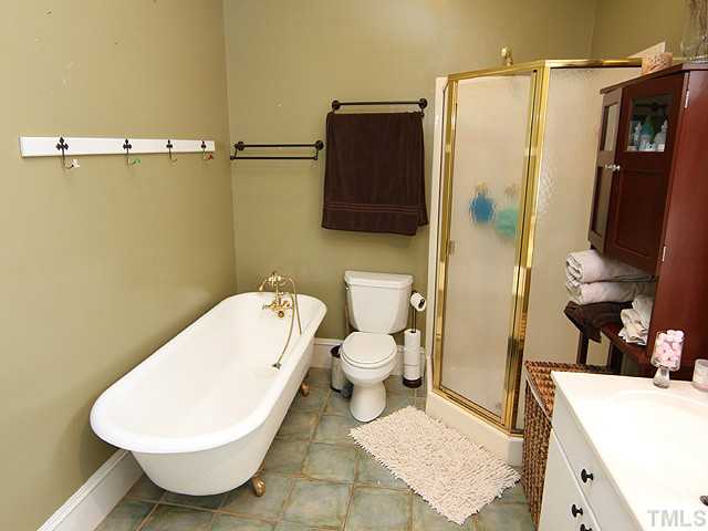 1406 Mordecai Drive Raleigh, NC 27604 - Photo 10 of 15 Enjoy Soaking In the Claw Foot Tub After a Long Day. Master Bath Offers Seperate Shower-Dual Sink Vanity-Designer Tile Floor