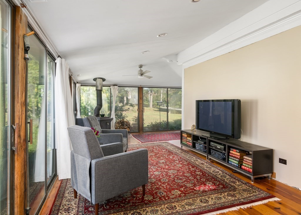 887 Broadway Hanover, MA 02339 - Photo 11 of 27 a living room with furniture and a flat screen tv