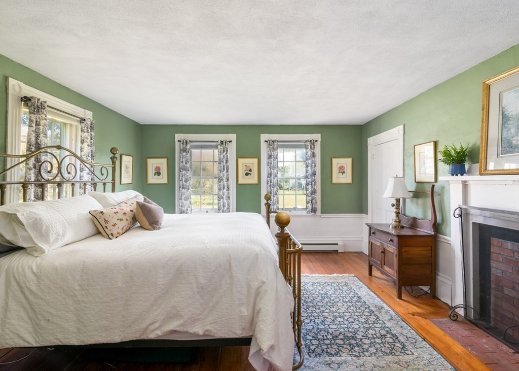 887 Broadway Hanover, MA 02339 - Photo 14 of 27 a bedroom with a large bed and a couch