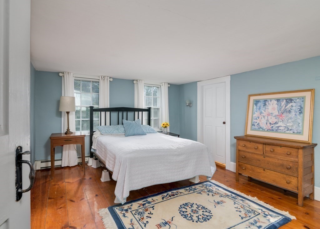 887 Broadway Hanover, MA 02339 - Photo 17 of 27 a bedroom with a bed and a dresser in it