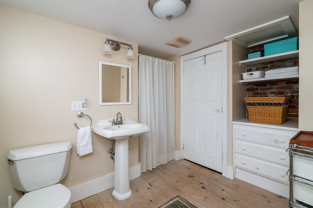 887 Broadway Hanover, MA 02339 - Photo 19 of 27 a bathroom with a sink a toilet and shower