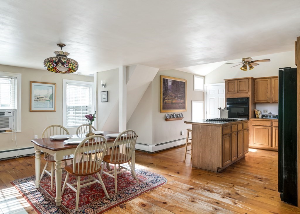 887 Broadway Hanover, MA 02339 - Photo 5 of 27 a living room with furniture a dining table and chairs